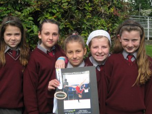 Alicja Drapala shows her medal and photo to her proud friends at school.